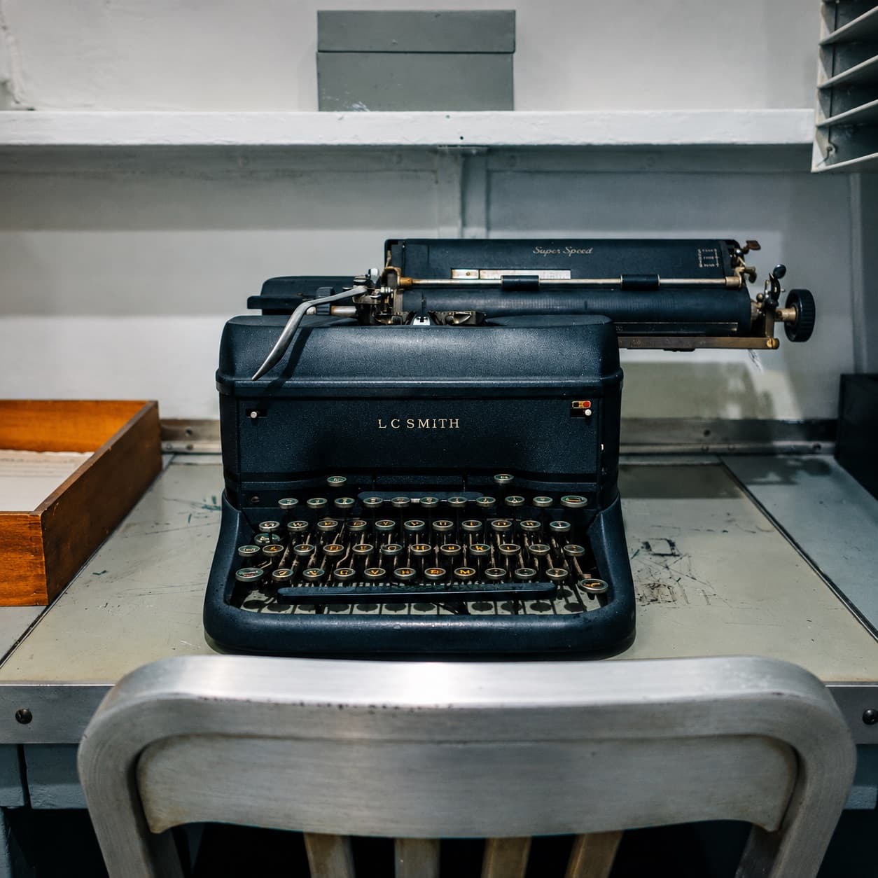 Vintage typewriter at a well-used workstation.